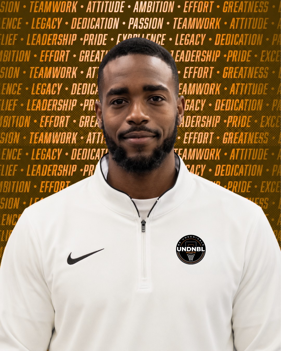 Coach Jackson Jacob in a black coach tracksuit standing on a basketball court