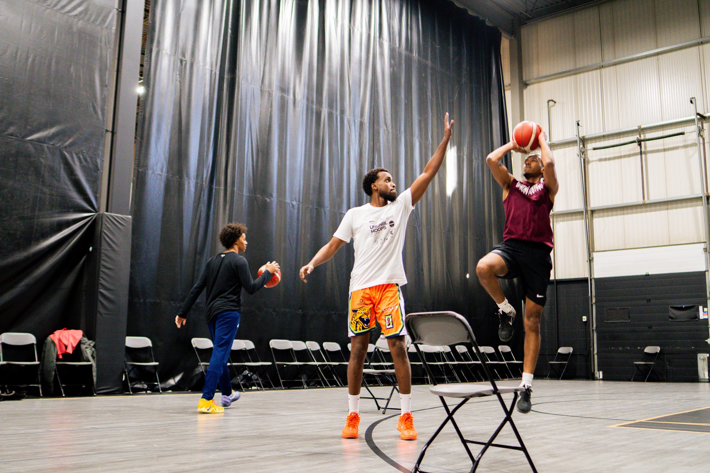 UNDNBL coach contesting a player's jump shot during training
