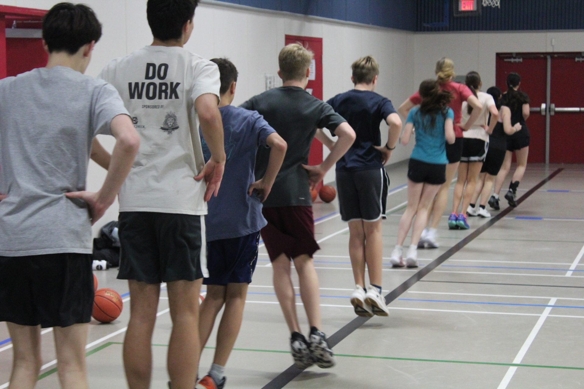 Athletes lined up doing footwork drills