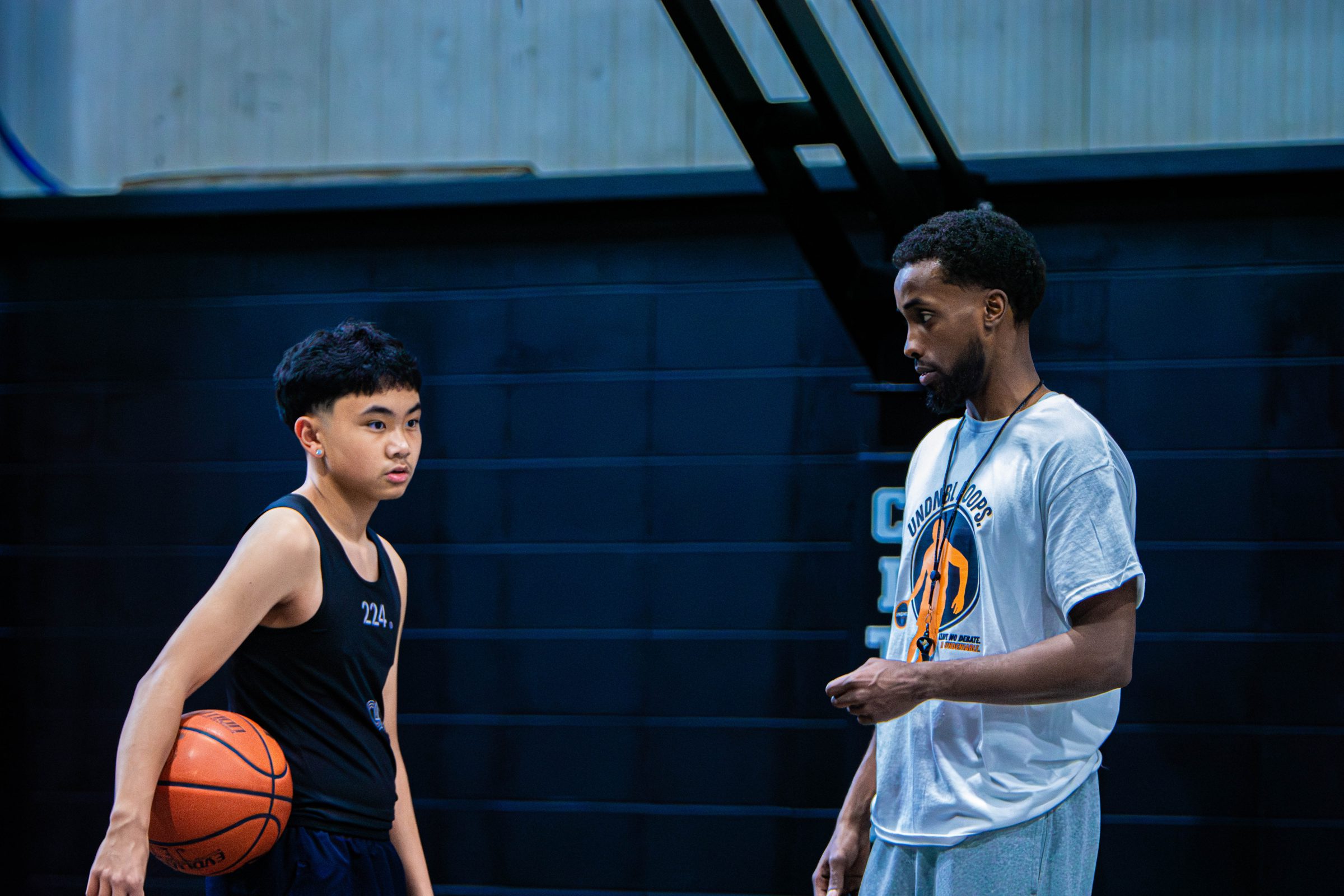 UNDNBL coach giving one-on-one instruction to a young player